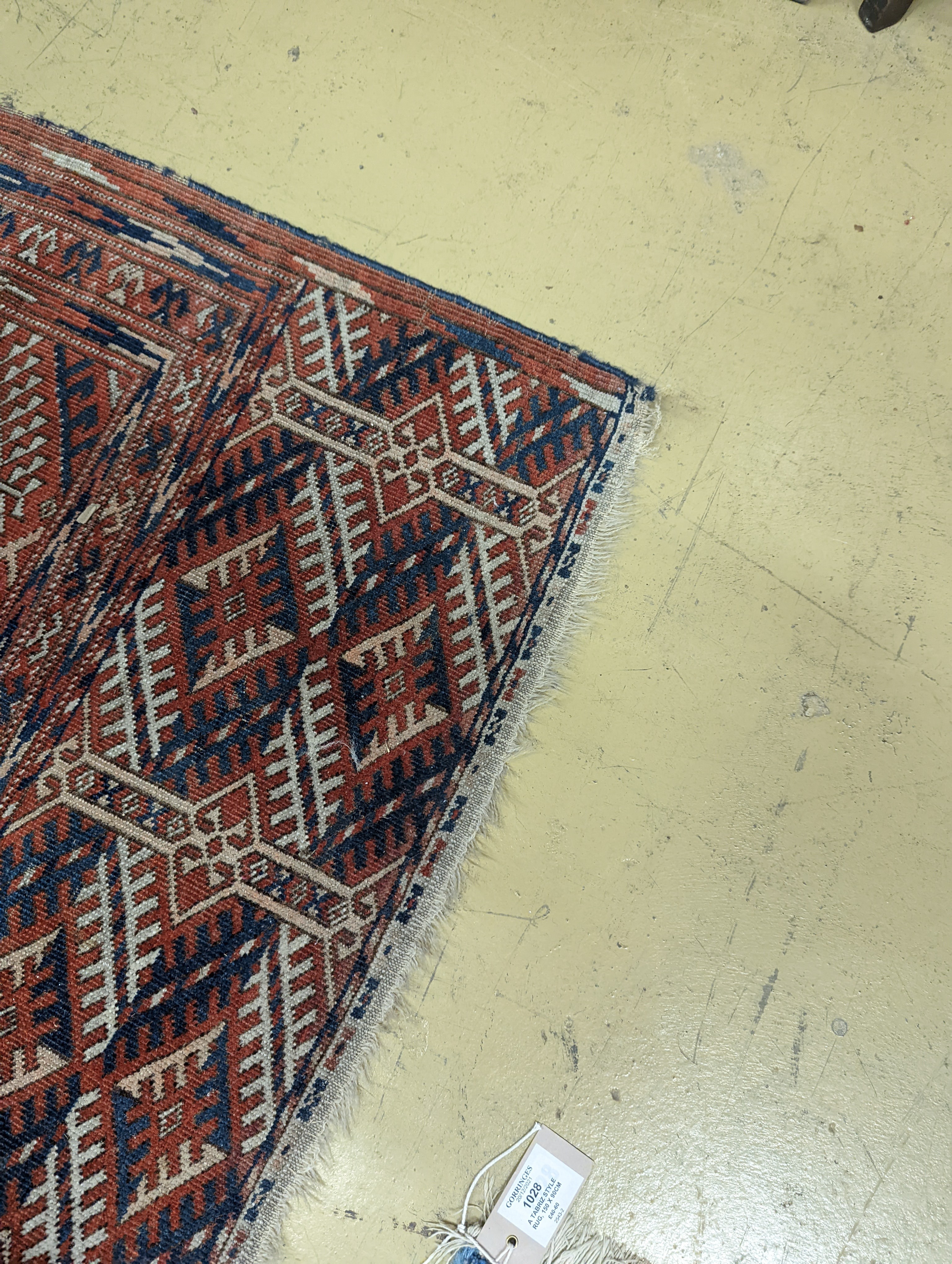 A Bokhara brick red ground carpet, 350 x 230cm